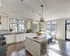 Custom Wood Work, Quartz Backsplash and island, Black trim, Heathered Absolute Black Granite Perimeter Countertop, Hickory Perimeter Island Countertop, Sunpan Barstools, Calligaris Table and chairs, Riverside, Greenwich, Wine Storage