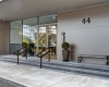 Brass Doors, Clean Store Front, Condo Entrance, Glass Entrance, Bluestone Steps, Champagne Metal Cladding, Sunpan Cement Bench