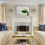 Carrara Fireplace surround, beige sofas, facing sofas, two coffee tables, symmetry, asymmetry, silk drapes